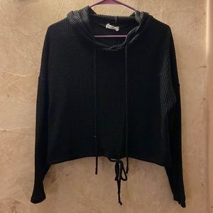 Black hoodie. Ties in front at bottom to make it tighter around your waist!